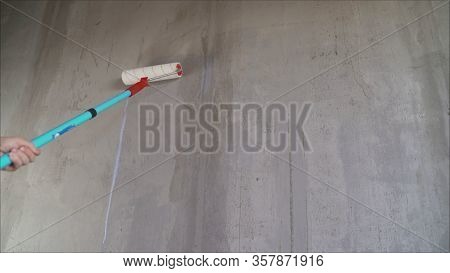 Paint The Bare Wall With A Paint Roller. Hand Painted By Roller. Primer Wall Roller