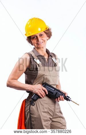 Happy senior woman holding a drill tool (isolated on white)