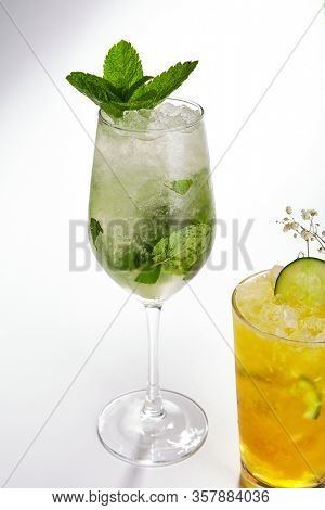 Mojito cocktail close up. Alcohol drink in glass top view. Refreshment beverage with rum, lime and mint leaves in drinkware. Exotic summer beach cocktail portion with crushed ice in glassware