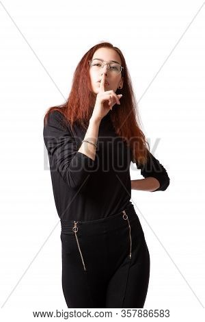 Attractive Woman In Styling And Bright Makeup In  Black Twater Jacket And Trousers  Holding A Finger
