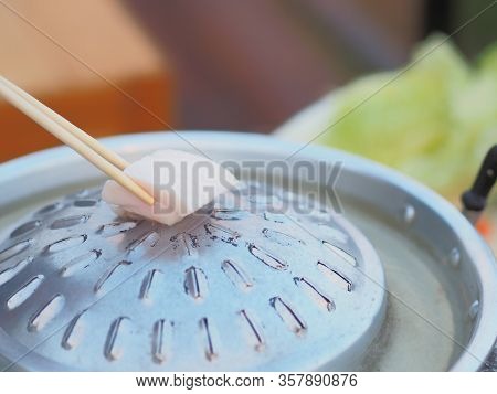 Closeup Place The Pork Fat Cubes In A Large Pan Or Wok Without Any Oil.   - Moo Katha In Thailand.