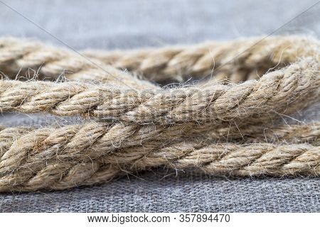 Dark Gray Rope Made Of Linen Material On A Linen Tablecloth. Close Up Of Rope
