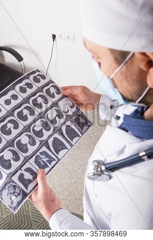 Doctor At Appointment Inspects And Examines Ct Scan Of Chest And Abdominal Cavity. Concept Photo On 