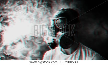 Man In A Gas Mask Smokes A Hookah And Breathes A Cloud Of Tobacco Smoke