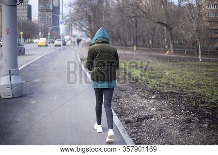 A Girl Is Walking Around The City. A Teenager Walks Alone. Unknown Person In The Hood. The Man Did N