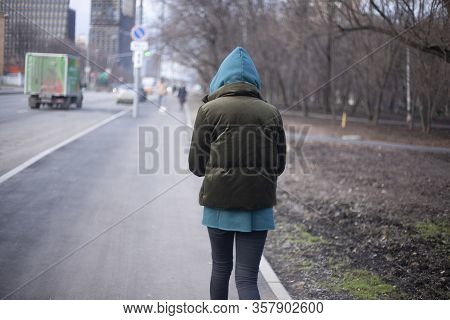 A Girl Is Walking Around The City. A Teenager Walks Alone. Unknown Person In The Hood. The Man Did N