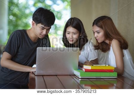 Asian Young Man And Woman Sitting Pointing Studying Examining, Tutor Books With Friends Young Studen