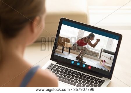 Interested Girl Watching Online Educational Fitness Workshop Training.