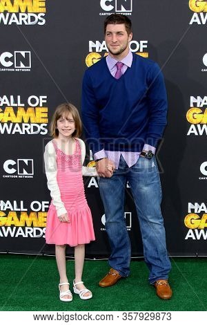 LOS ANGELES - FEB 18:  Tim Tebow and Guest at the 2012 Cartoon Network Hall of Game Awards at the Barker Hanger on February 18, 2012 in Santa Monica, CA