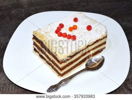 Tea Cake With Red Lingonberries On A White Plate