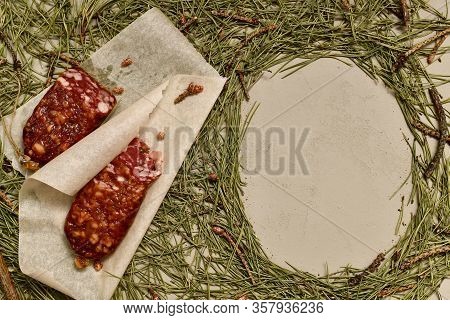 Dried Beaver Meat Sausage And Pine Buds On Parchment Paper On The Left And An Empty Frame Of Pine Ne