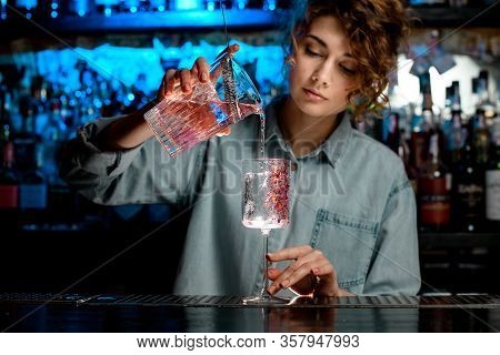 Lady Bartender Pours Pink Cocktail Into Wineglass