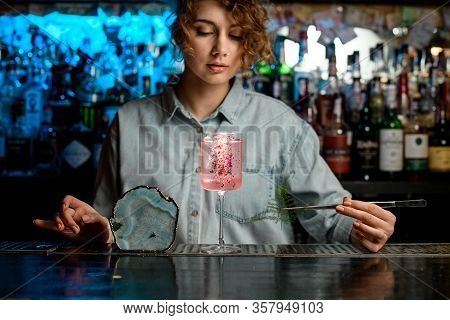 Wineglass With Pink Drink Decorated By Pieces Of Rose Petals Standing On Bar Counter.