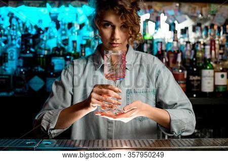 Pretty Lady Barman Carefully Holds Glass In Her Hands.