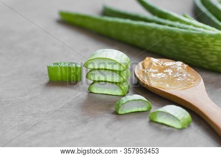 Aloe Vera Gel Close-up. Sliced Aloe Vera Plants Leaf And Gel With Wooden Spoon , Natural Organic Cos