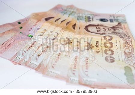 Stack Thai Baht Banknotes, Businessman's Hands Counting Money. One Thousand Baht With Tag Text In Th