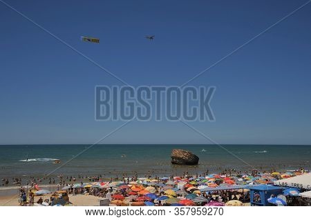 Matalascanas, Spain - July 10, 2011:light Aircraft With Ads Above The Beach In The Resort Town Of Ma