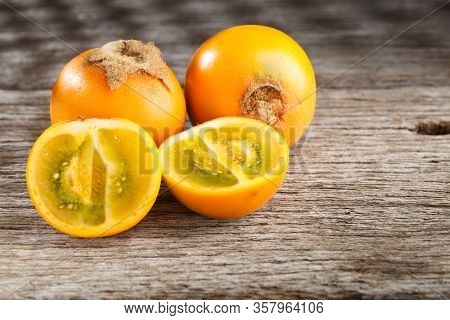 Fruit Of Lulo Or Naranjilla On Wood