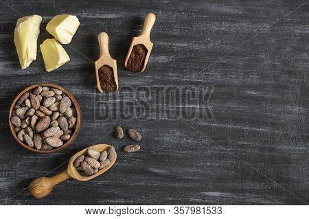 Cocoa Butter Or Cocoa Bean Solid Oil With Cacao Powder In Spoon Or Bowl And Raw Cocoa Beans On Rusti