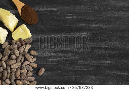 Cocoa Butter Or Cocoa Bean Solid Oil With Cacao Powder In Spoon Or Bowl And Raw Cocoa Beans On Rusti