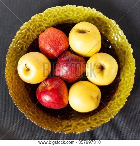Colorful Fruits On Glass Plate On Black Background. Top View. Red And Yellow Apples, Multivitamins O