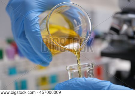 Pouring And Mixing Chemicals Closeup. Laboratory And Scientific Experiments. Petroleum Formulation O