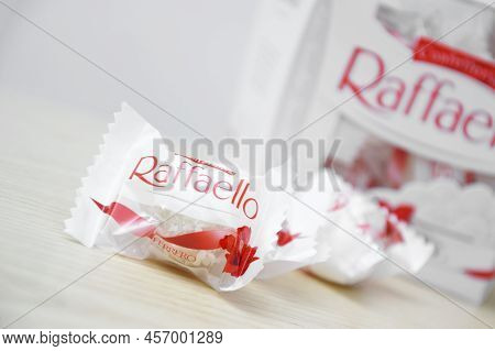Raffaello Sweets On A Light Wooden Table And White Background.