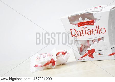 Raffaello Sweets On A Light Wooden Table And White Background.