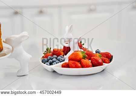 Strawberries And Blueberries In A White Compartmental Dish With Rabbit.