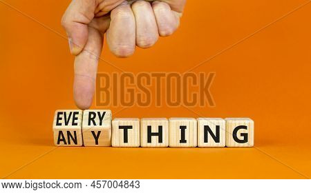 Anything Or Everything Symbol. Businessman Turns Cubes, Changes The Concept Word Anything To Everyth