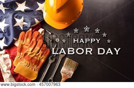 Happy Labor Day Concept. American Flag With Different Construction Tools And The Text On Dark Stone 