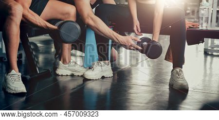 Sporty Woman And Man Working Out With Trainer At Fitness Gym. Health And Wellbeing Lifestyle.