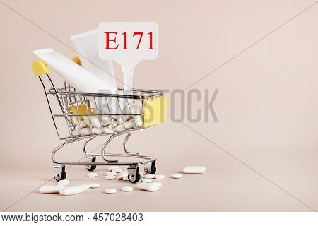 Titanium Dioxide, E171, Dangerous Additive Concept. Gum, Pills, Toothpaste, Cream In Basket And Sign