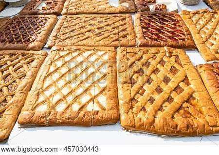 Large Flat Sweet Open Pies Filled With Various Jams And Cheese On Table