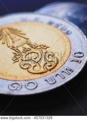 Translation: 10 Baht Thailand. Thai Coin Of 10 Baht Lie On Dark Surface. Economy Or Finance. Loan An