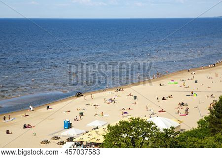 Latvia, Jurmala, June, 26, 2021 - People Enjoying Relaxing On The Baltic Sea Beach In Jurmala, Latvi