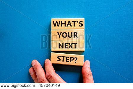 What Is Your Next Step Symbol. Concept Words What Is Your Next Step On Blocks. Businessman Hand. Bea