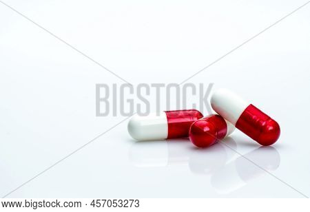 Macro Shot Detail Of Red, White Antibiotics Capsule Pills Isolated On White Background With Copy Spa