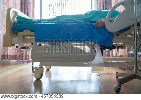 An Urine Bag Hanging Beside The Patient's Bed. Inside The Hospital Room. Medical Concept.