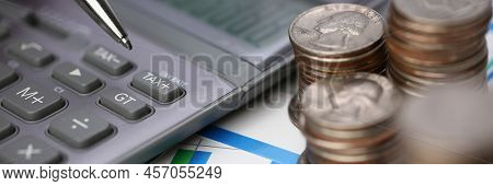 Close-up Of Silver Calculator With Keyboard Lying On Desk Cash Quarter Plots In Home Office Setting.