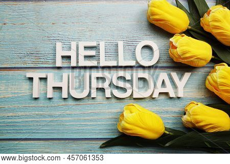 Hello Thursday Alphabet With Yellow Tulip Flower On Wooden Background