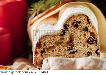 Christmas Stollen On Wooden Background. Traditional Christmas German Dessert Cut Into Pieces. Cake W