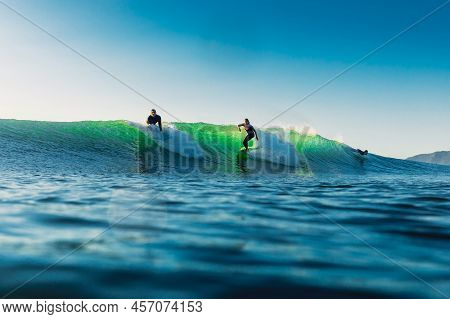 February 15, 2022. Brazil, Florianopolis. Woman During Surfing In Ocean. Surfer Girl Ride On Surfboa