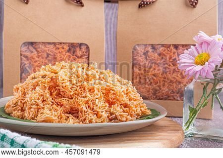 Sweet And Sour Crispy Noodles Or Mee Krob In The Thai Language On A Dish With Cloth, Vase Placed On 