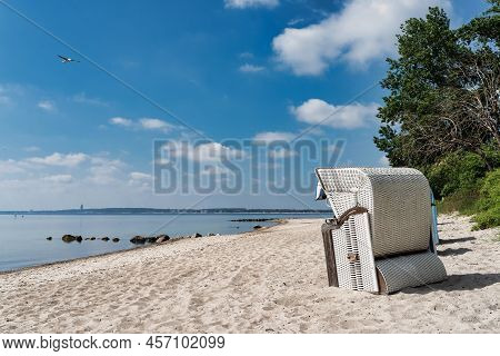 Traditional Canopied Beach Chair On Beautiful Baltic Sea Beach On Sunny Day