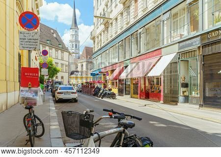 Ancient Street Of European City With Ancient Architecture, Multi-colored Storefronts And Building Fa