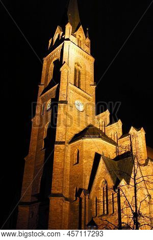 Gothic Cathedral Church Structure With Clock Tower In Night Illumination In Guben, Germany.