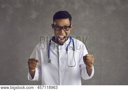 Young Emotional African American Doctor Clenched His Fists And Shouted Hurray.