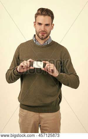 Handsome Man With Stylish Hair Showing Debit Card Isolated On White, Copy Space, Payment