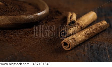 cinnamon ground sticks ceremony cocoa cloves ground coffee spices on wooden table closeup